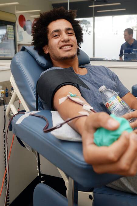 BLOOD DONOR: Ballarat podiatry student Joshua Pyalanda rolls up his sleeves to donate plasma at the Ballarat Blood Collection Service. Picture: Kate Healy