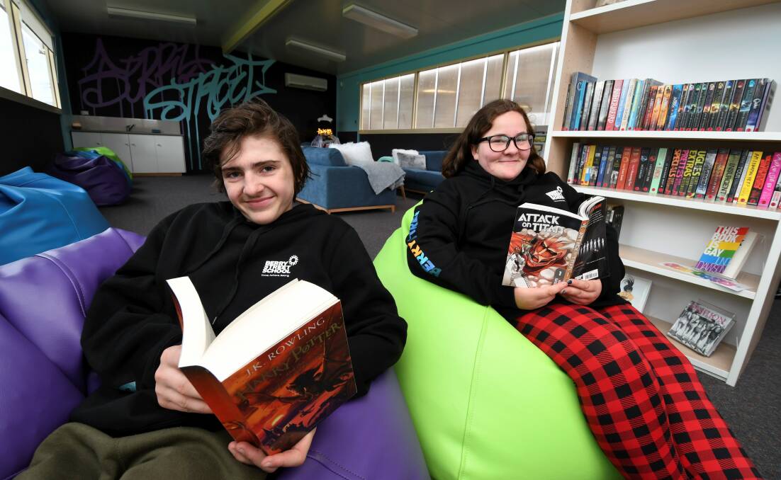 READERS: Berry St School students Lachlan, 14, and Rachael, 14, grab their favourite books off the shelf as they enjoy some quiet reading time in the school's new library. Picture: Lachlan Bence