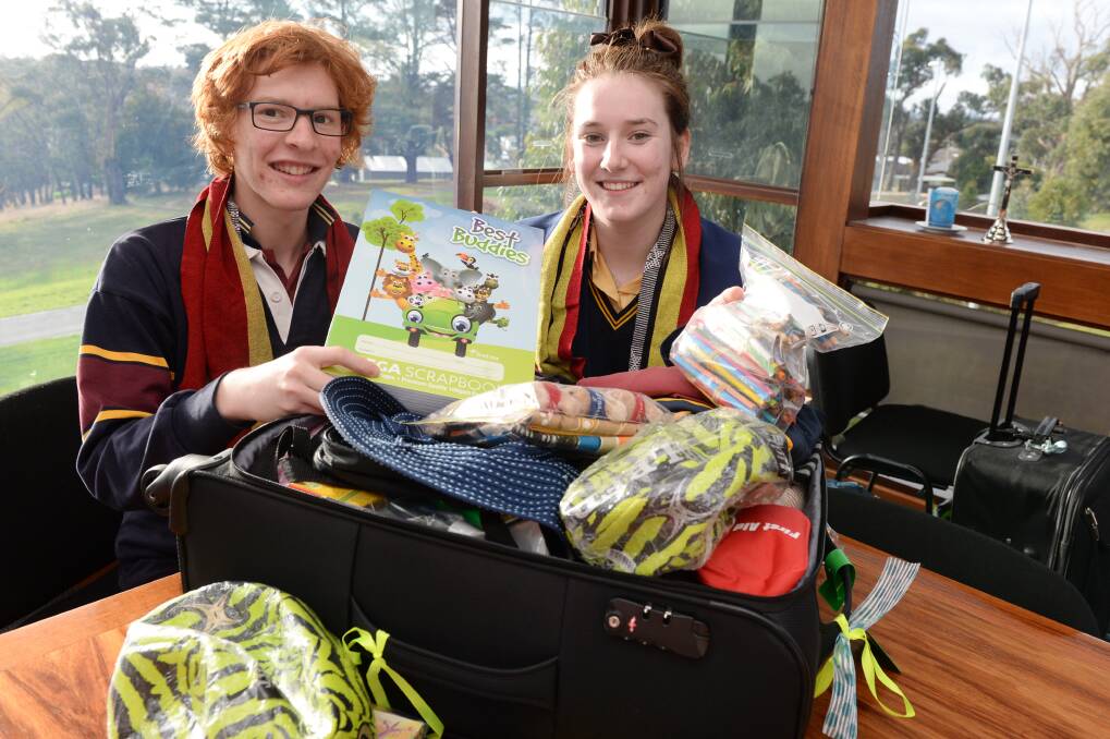 DONATIONS: Damascus College students Tom Carter, 16, and Callie Lee, 17, pack bags with supplies for East Timor. Picture: Kate Healy