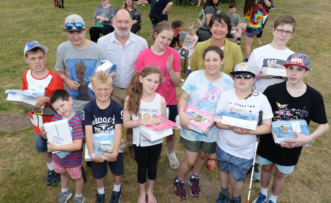 IPADS ALL AROUND: Creswick Lions Club president Peter Cowie and Labor MP Michaela Settle with Keeley Murphy (centre) and some of the 18 children with autism who received iPads from Keeley's Cause at the foundation's Christmas celebration. Picture: Kate Healy