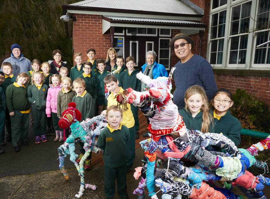 FAMILY PHOTO: Warrenheip Primary School staff and students with artists Ruth Graham and Diokno Pasilan and their new additions, sculpture dogs Rosie and Sandy made from recycled sticks and clothing. Picture: Luke Kauzlaric
