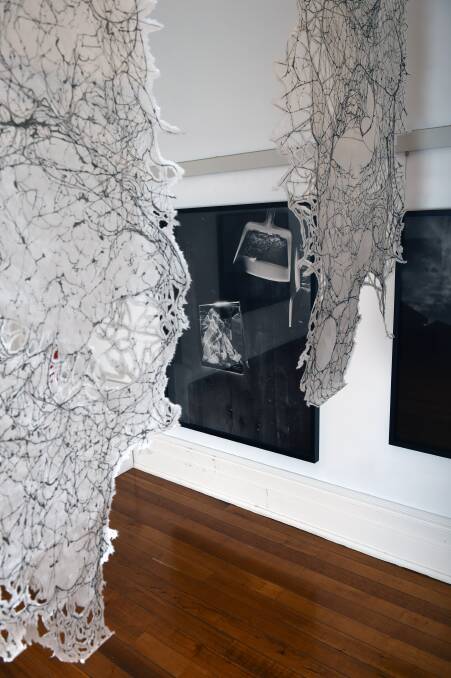 THOUGHT-PROVOKING: Trent Parke's pigment print Shattered Portrait seen through Kim Anderson's hanging artwork The Space Between. Picture: Kate Healy