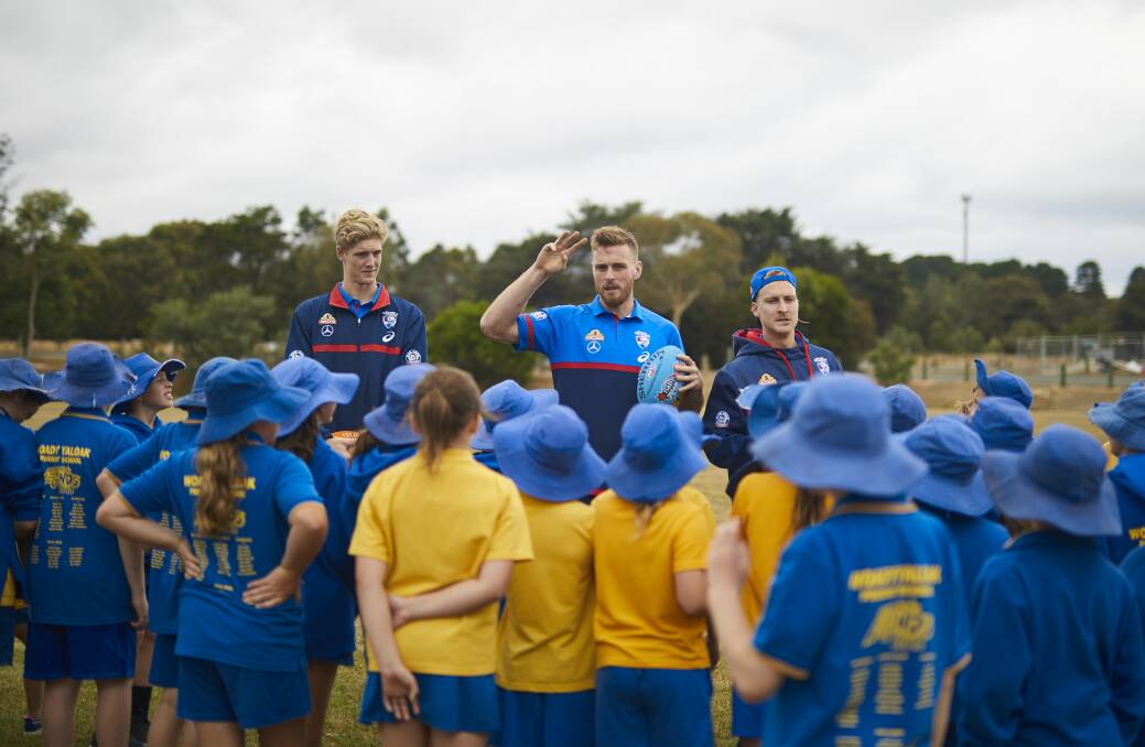 ALL EARS: Woady Yaloak pupils listen intently as Jordan Roughead explains the training drills that he, Tim English and Shane Biggs will conduct. Picture: Luka Kauzlaric