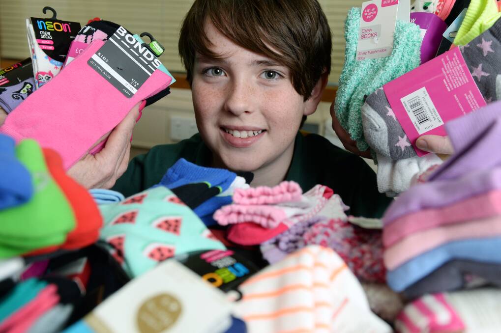 Raining socks: Oscar Broad, 12, is dedicating his time to help Ballarat's homeless and underprivileged through a community Facebook page. Picture: Kate Healy