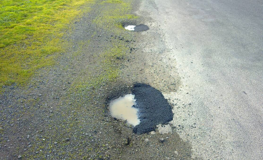 Waterlogged: The maintenance job on these potholes in Miners Rest has angered local residents. Picture: contributed