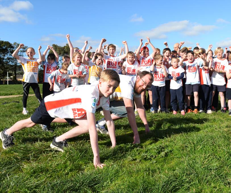 On your marks: Miners Rest Primary School grade 5 pupil Jack Diamond and teacher Ben Mitchell in front of the school's running cohort. Picture: Kate Healy