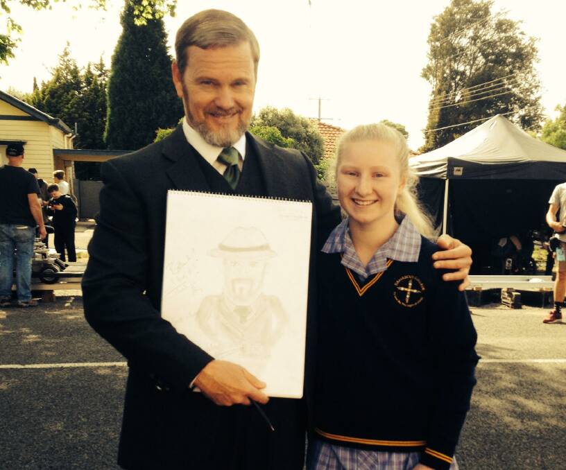 Ballarat teen Amy McGee shows her drawing of Dr Blake to the man himself