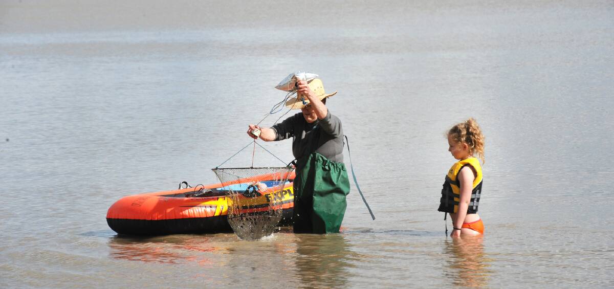 FISHING: Dianne Brown and Taylah Hall looking for yabbies at Green Lake on Saturday. Picture: PAUL CARRACHER