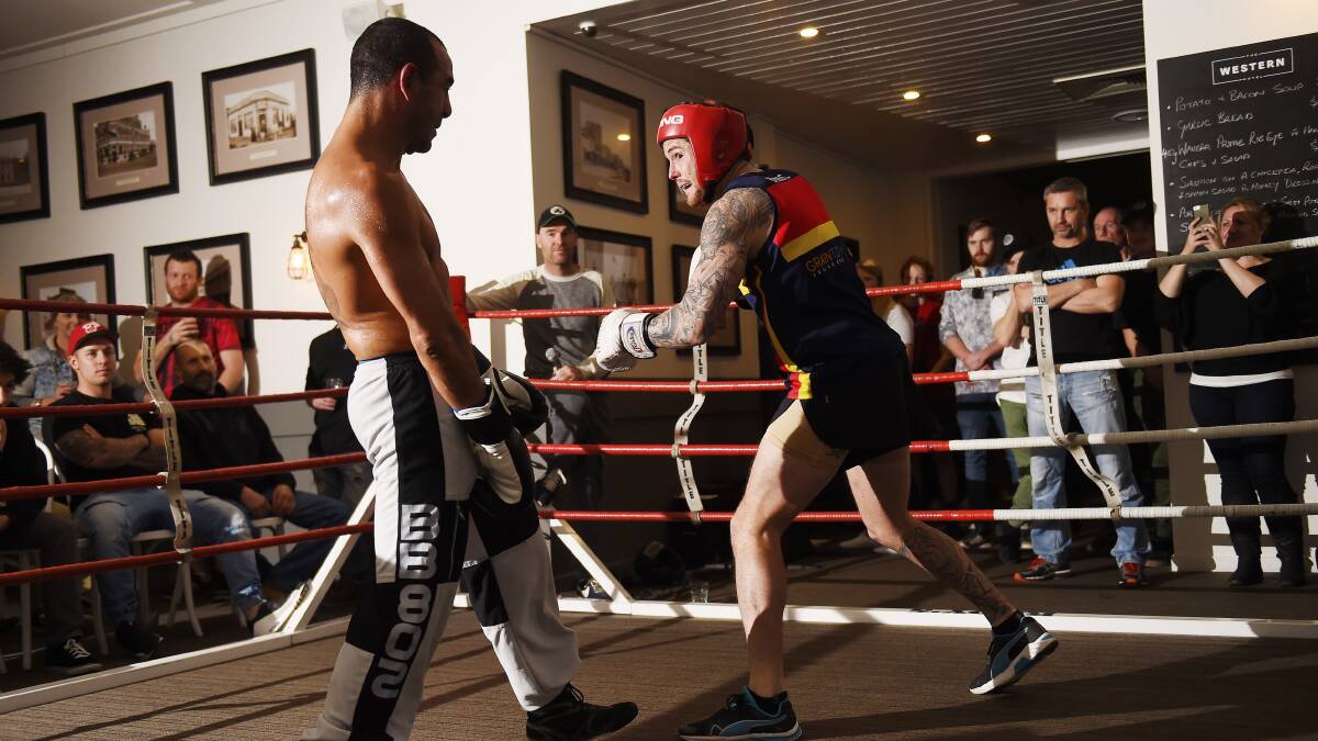 BATTLE: Beaufort footballer Lee Marshall takes on Sam 'King' Soliman at a charity event. Picture: Luka Kauzlaric. 