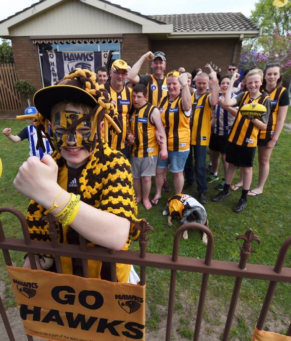 BIGGEST FANS: Eathan Henderson, 13, and his family and friends were never in doubt their Hawks couldn't come away with another win on Saturday. Picture: Lachlan Bence.
