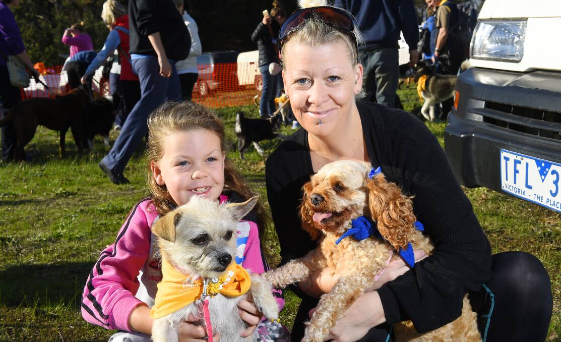 PAWS UNITE: Shalayla Harris and Tanya Harris with Stella and Milly were among more than 600 pooches and their owners who joined in the 5km walk.