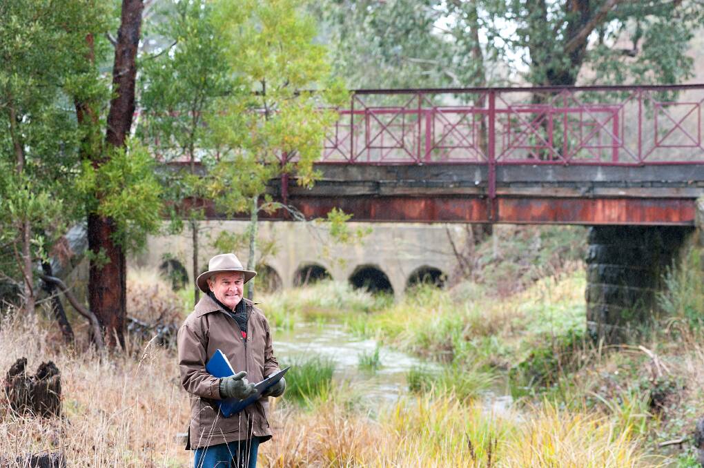 HARD AT WORK: Michael Keaney from Trentham and District Landcare on the Coliban River near Enders Bridge. Picture: Sandy Scheltema. 
