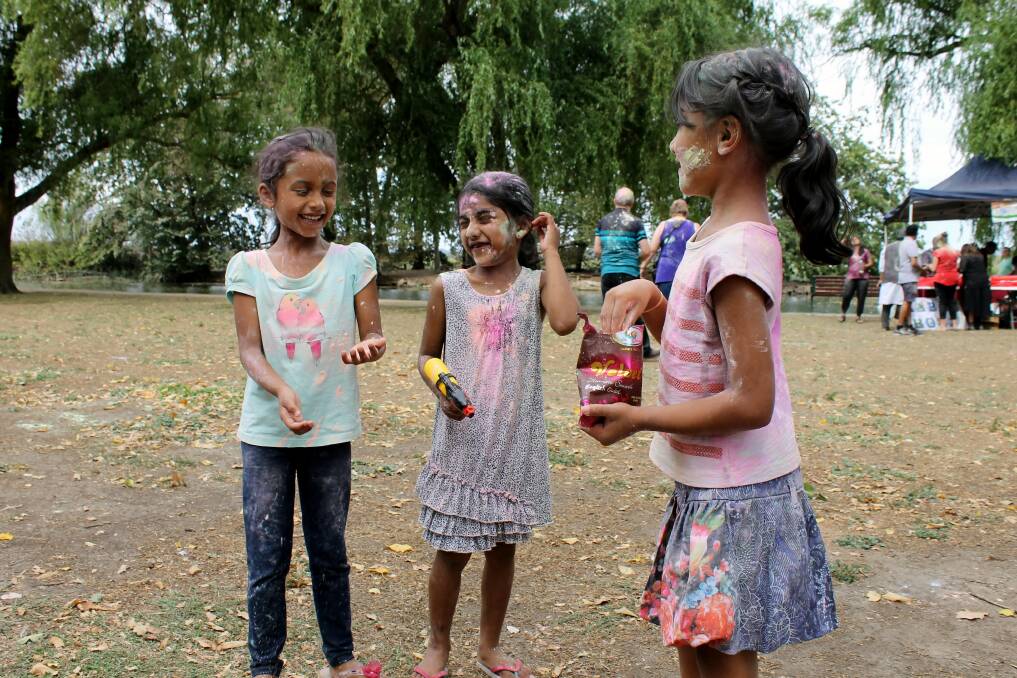 LAUGHTER: Hana, Livia and Ankita throw coloured powder as part of Indian Festival of Holi. Picture: Rochelle Kirkham 