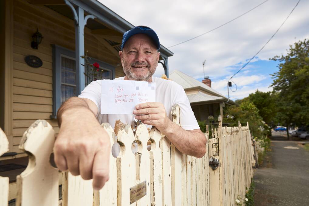 Darryl on Doveton Ct with his letter containing $20. Picture: Luka Kauzlaric 
