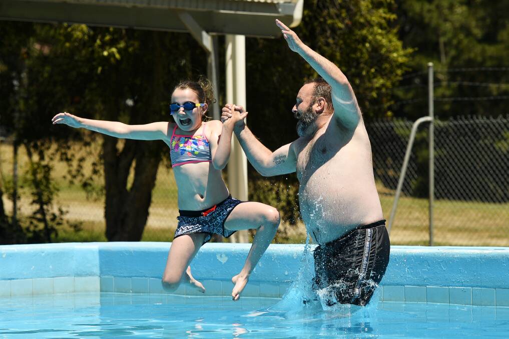 Wayne Crooks and Mackenzey Crooks, 9, making a splash at the Black Hill Pool. Picture: Dylan Burns 