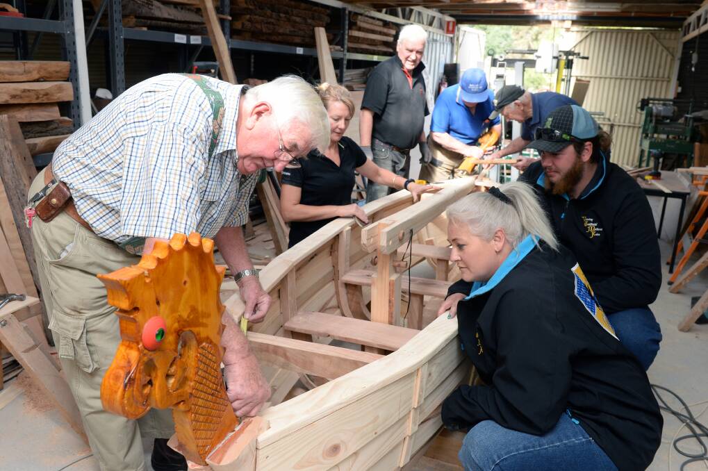 VIKING TIMES: George, Jenene Lamb, Keith Moss, David Ludbrook, Max Brown, Dave Williamson and Rebecca Poltorasky are working to make the final touches to the Ballarat Woodworkers Guild Viking longboat in time for the Victorian Goldfields Medieval Faire. Picture: Kate Healy 
