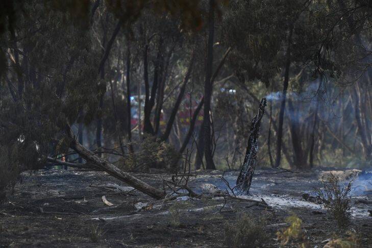 Burnt out land is seen at Carrum Downs in Melbourne, Saturday, January 6, 2018. Residents in western Victoria are being told it's too late to leave and to take shelter now as a fire rages in extreme conditions. (AAP Image/James Ross) NO ARCHIVING