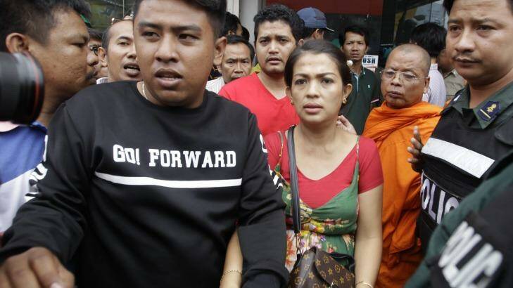 Phou Ratana, center, wife of Cambodia's prominent political analyst Kem Ley, arrives at a shopping mall where her husband was shot dead in Phnom Penh. Photo: Heng Sinith