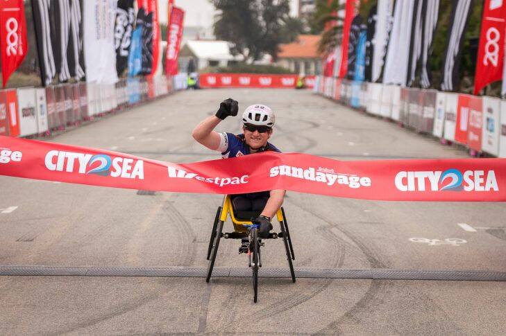 Richard Colman crosses the finish line in 1st place of the 5km wheelchair race during the Sunday Age City2Sea, in Melbourne. November 12th 2017. Photo: Daniel Pockett