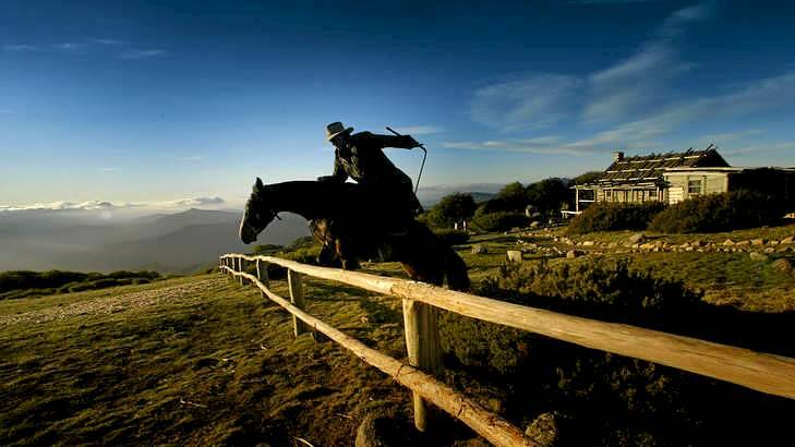 High country grazer Adam McCormack guides a horse over a fence at Mount Stirling's Craig's Hut, which was built for the filming of the movie <i>The Man From Snowy River</i> in the `80s. Photo: Simon O'Dwyer