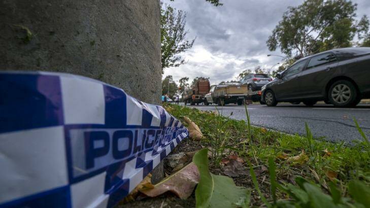 Police tape at the crime scene, where two men in their 30s were found with suspected gunshot wounds in a white ute in Parkville Photo: Luis Ascui