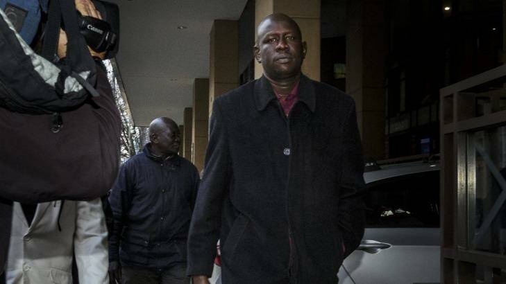 Joseph Tito Manyang, the father of the three children killed when the car went into the lake, outside Melbourne Magistrates Court on Monday. Photo: Daniel Pockett