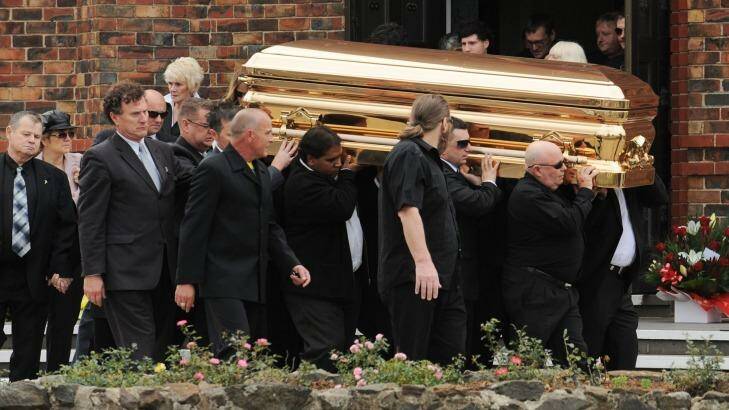 Carl Williams' gold-plated coffin is carried from St Therese's church in Essendon in April 2010.  Photo: Vince Caligiuri