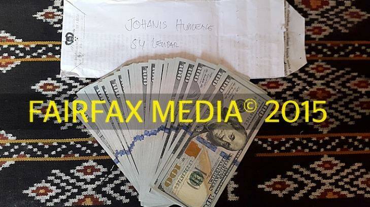 One of six: Money used to pay people traffickers in Indonesia, and the envelope that carried it. Photo: Fairfax Media