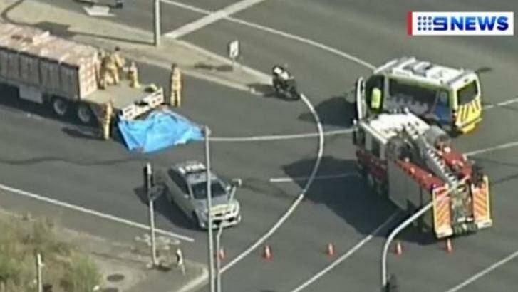 Emergency services work to free the woman from underneath the truck, January 12, 2017. Photo: Channel 9