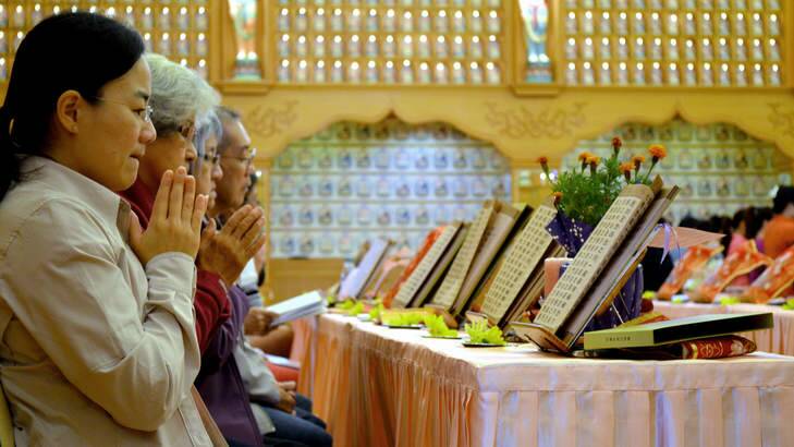 Sombre: The Chinese Buddhist community in Perth held a special prayer ceremony for the missing passengers of flight MH370 and their relatives and friends. Photo: Amy McNeilage