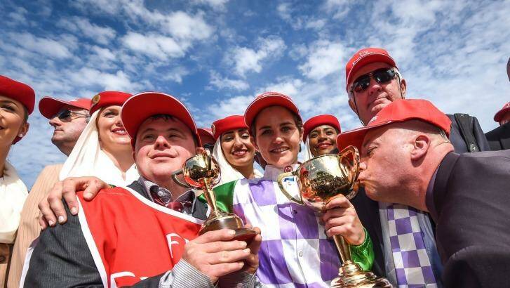 Stevie Payne, left, with sister Michelle, trainer Darren Weir and one of the owners kissing the cup. Photo: Justin McManus