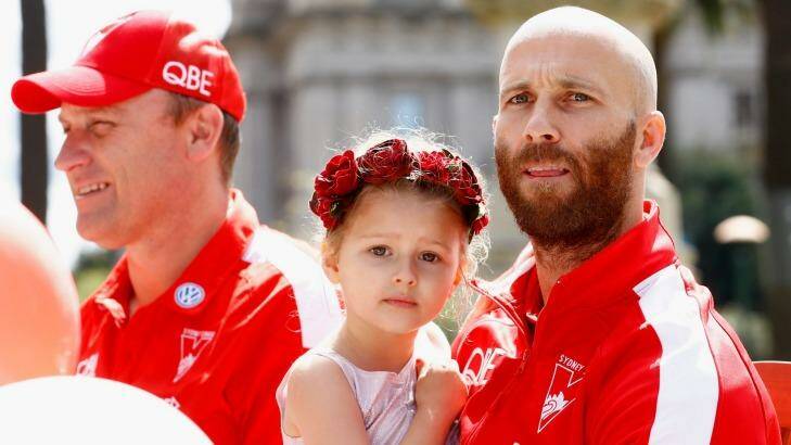 Jarrad McVeigh and his daughter take part in the parade. Photo: Darrian Traynor
