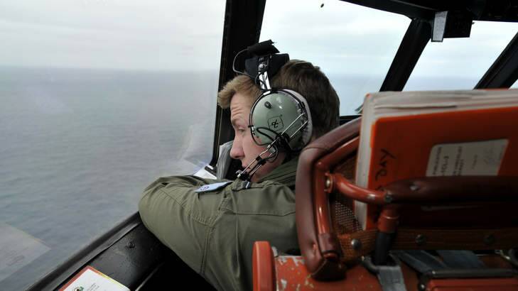 Flying Officer Benjamin Hepworth searches from a Royal Australian Airforce AP-3C Orion from Pearce Airforce Base during a search mission for possible MH370 debris on March 21, 2014 in Perth. Photo: Pool