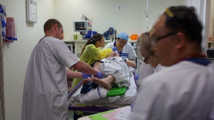 A patient is treated in St Vincent's Hospital after the Bourke Street rampage. Photo: St Vincent's Hospital