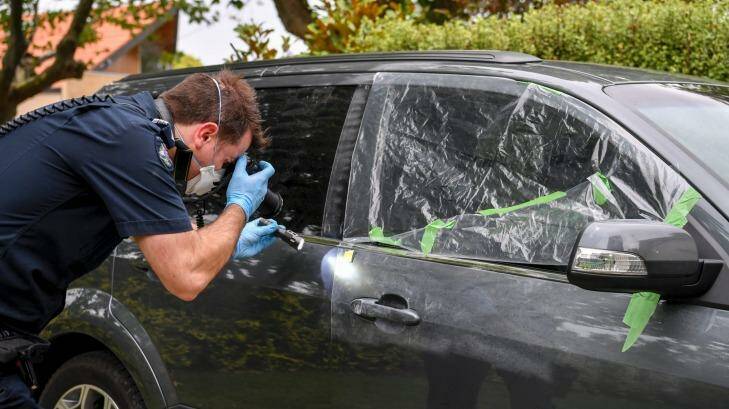 Crime Scene Officer Glen Finlay looks for finger prints on a Ford Territory on Chaucer Avenue. Photo: Eddie Jim