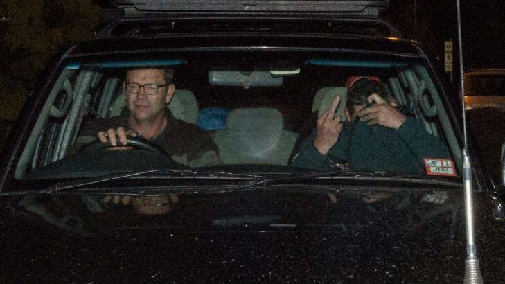Mark Tromp, pictured right, is driven from the Wangaratta police station on Saturday night. Photo: Mark Jesser