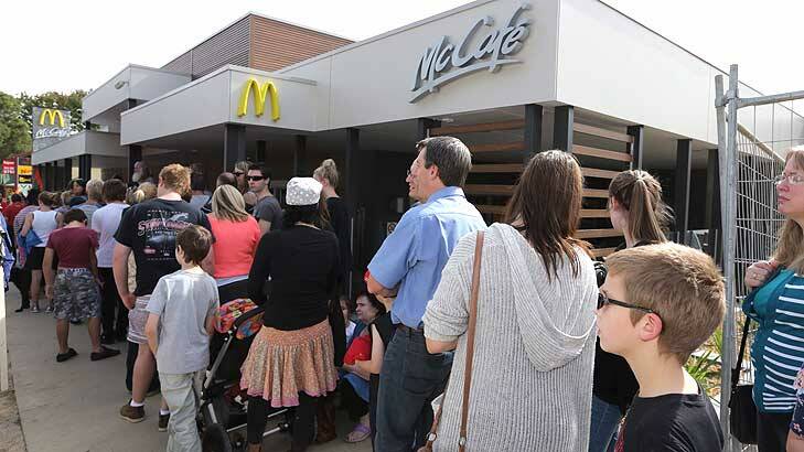Would you like fries with that? The line-up of customers waiting to get inside the new Tecoma McDonald's far outnumbers protesters. Photo: Wayne Taylor