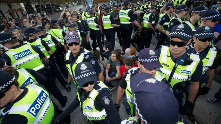 Police surround protesters on the Spring Street tram tracks. Photo: Jason South