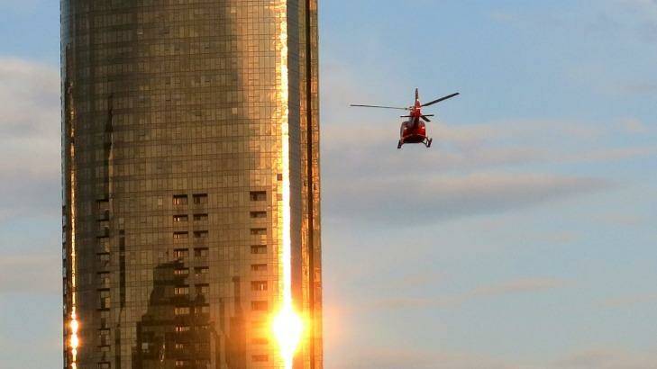 A helicopter flies through Melbourne skyscrapers along the Yarra River. Photo: Leigh Henningham