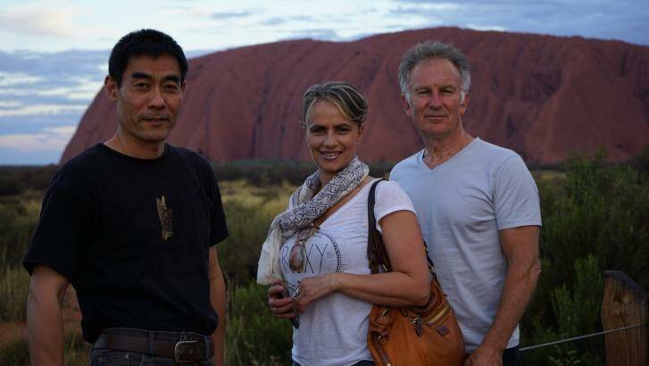 Zhou Xiaoping, Diamond Rozakeas and Brian James take in the beauty of Uluru. Photo: Supplied