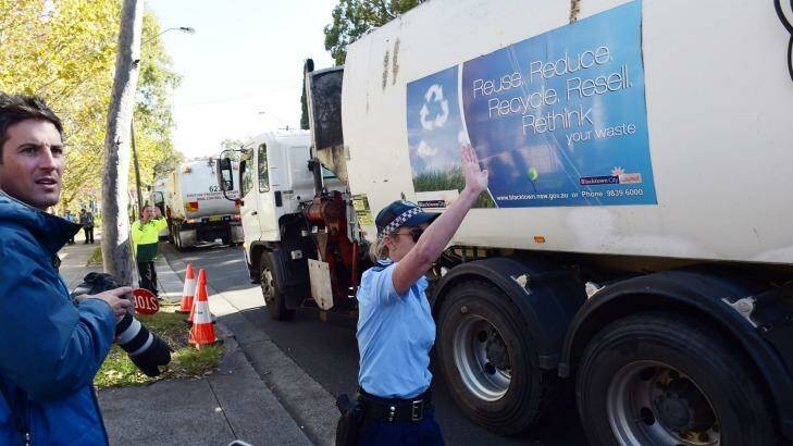 Police guide garbage trucks from Blacktown during the May 2015 protest against the SBS show <i>Struggle Street</i>, before the first episode aired. Photo: Nick Moir