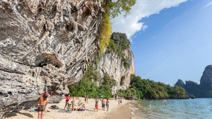 Rock climbers and tourists on Railay beach, one of the most popular rock climbing locations in Asia.  Photo: iStock