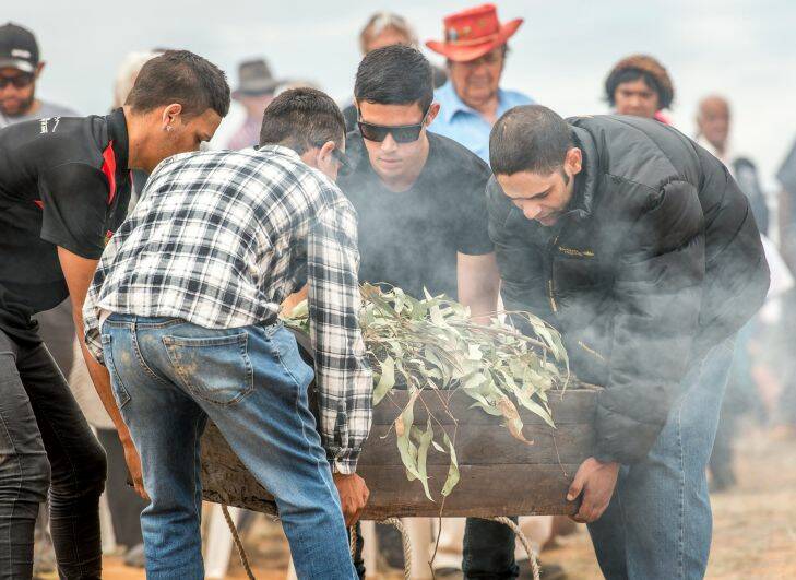 The Age, News, 17/11/2017, photo by Justin McManus.
Repatriation of Mungo Man's remains along with 104 other ancient ancestors back to conutry at Lake Mungo. The remains will be taken from thre National Museum of Australia's  storage faciclity in Canberra in the old Aboriginal hearse accompanied by elders from the Willandra region - the Mutthi Mutthi, Paakantyi?????? and Ngiyampaa?????? people. They will travel and be welcomed with ceremony from local elders at Wagga Wagga, Hay and Balralnald before being laid to rest at Lake Mungo.
The 5000 year old redgum box containing Mungo mans remains is placed back on country after a 40 fight to have them repatriated.