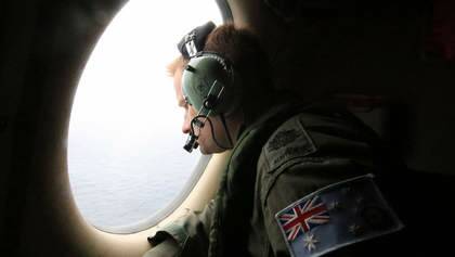 A photo taken on March 21, 2014, shows a crew member on a Royal Australian Air Force AP-3C Orion aircraft participating in the Australian Maritime Safety Authority-led search for Malaysia Airlines Flight MH370 in the Southern Indian Ocean. Spotter planes spent a second fruitless day scouring a remote stretch of the Indian Ocean for wreckage from a Malaysian jet.  Australian and US military aircraft usually used for anti-submarine operations criss-crossed the isolated search area 2,500 kilometres (1,500 miles) southwest of Perth, looking for two floating objects that had shown up on grainy satellite photos taken several days before.  AFP PHOTO - POOL / BOHDAN WARCHOMIJ Photo: BOHDAN WARCHOMIJ