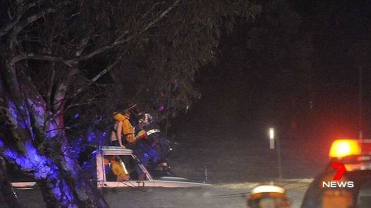 Man and girl stranded in floodwaters at Inverleigh on Wednesday night. Photo: Courtesy of Seven News