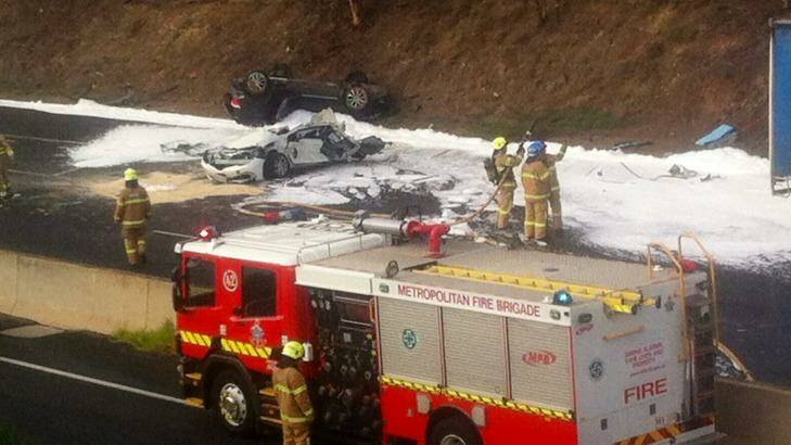 A black 4WD flipped and a white car crushed on the Calder Freeway. Photo: Ben Millar