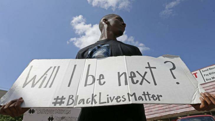 Niamke Ledbetter, of Oak Cliff, Texas, holds a sign at a Black Lives Matter protest in Dallas on Sunday. Photo: Dallas Morning News/AP