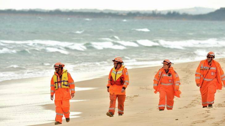 SES members searching the beach at Point Lonsdale on the day of the plane crash. Photo: Joe Armao