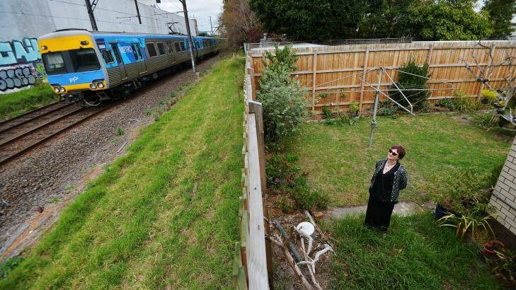 Michelle Clarke in the backyard of her Carnegie home which backs on to the rail tracks where the sky rail will be built. Photo: Joe Armao