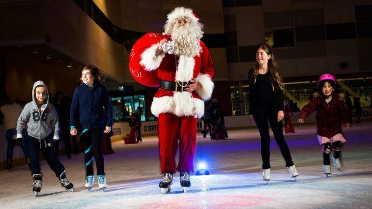 Cooler Santa: A lucky Father Christmas got a gig ice skating at O'Brien Group Arena in Docklands. Photo: Chris Hopkins